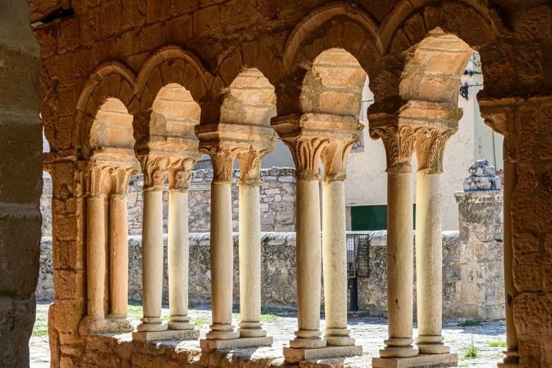 a stone wall with a number of small columns