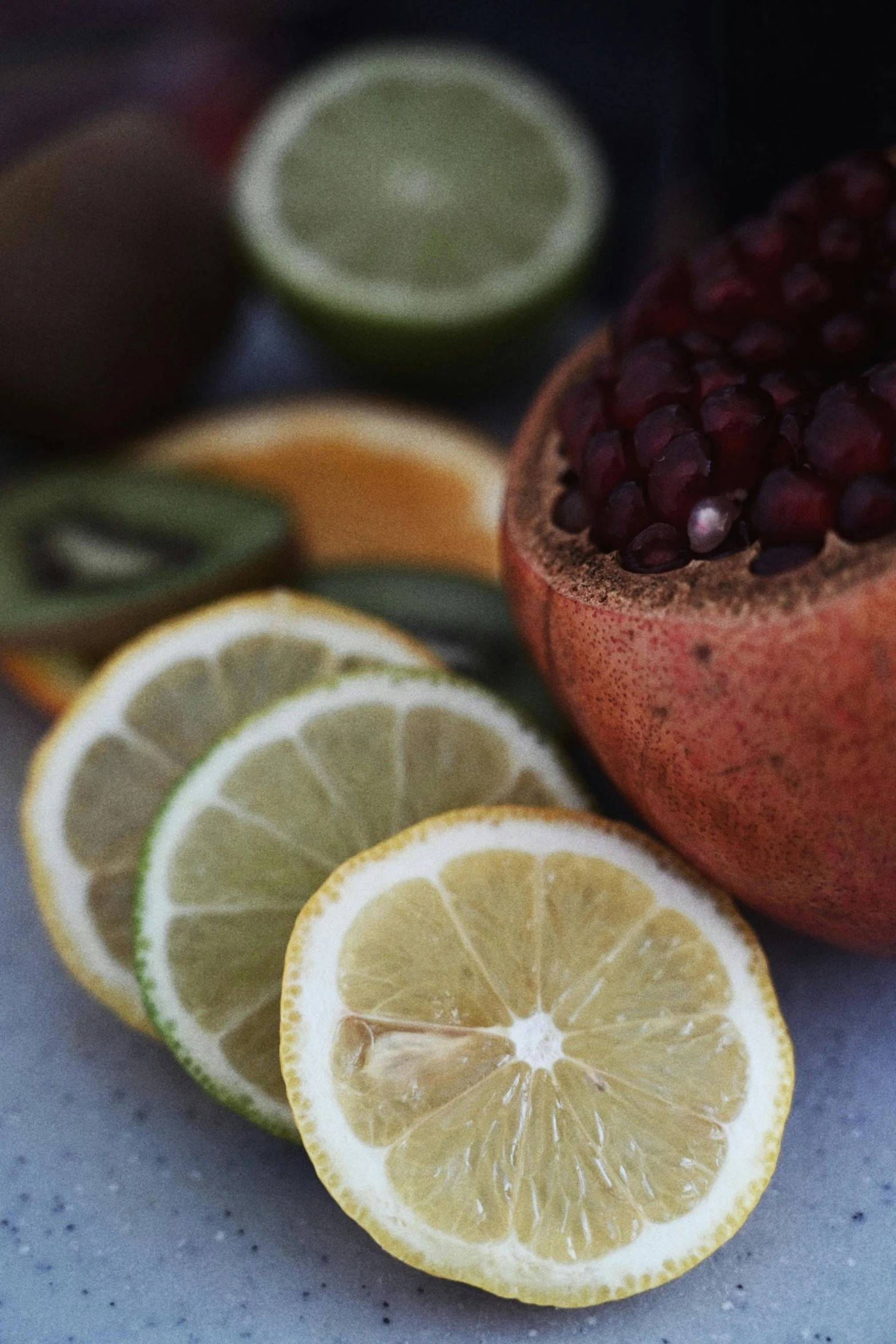 fruit cut in half on a table next to other fruits