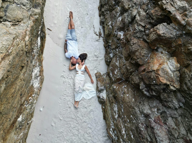 a man and woman on the beach next to each other