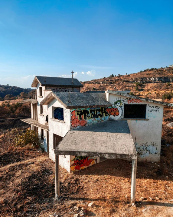 the abandoned buildings in an area is covered in graffiti