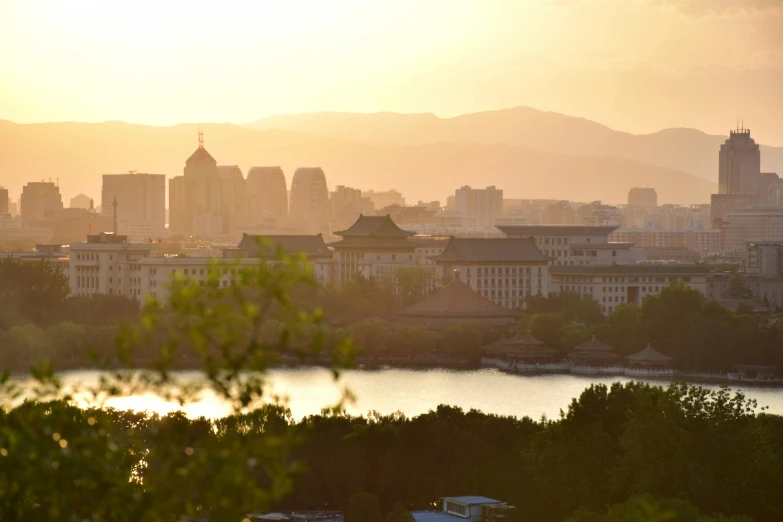 sunset over an area that contains buildings and a body of water