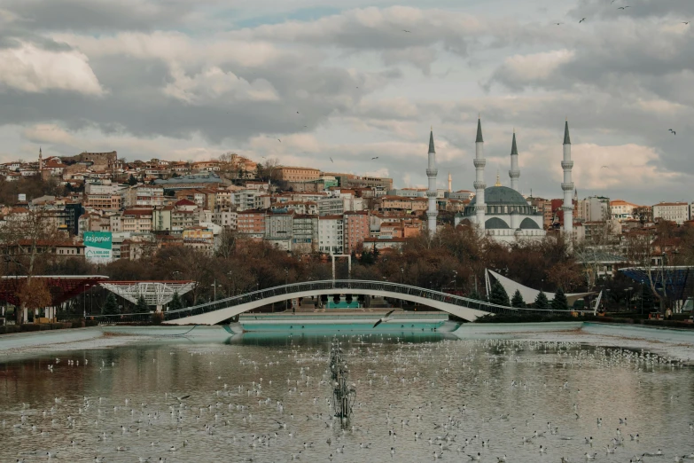 a large bridge over a lake near a tall building