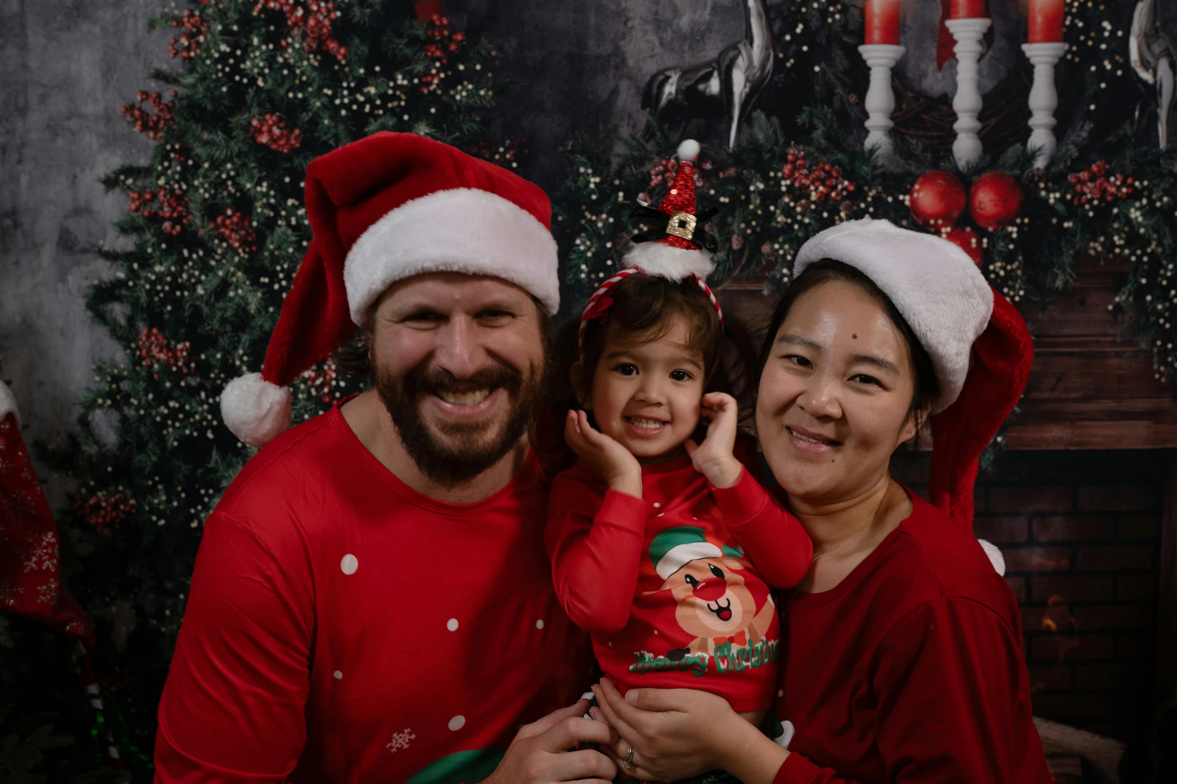 a man and a woman dressed in matching christmas apparel