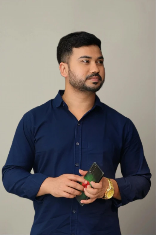 a man in blue shirt holding a remote control