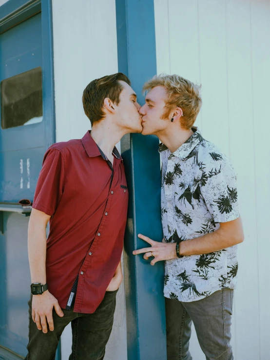 two people kissing with their heads on each other