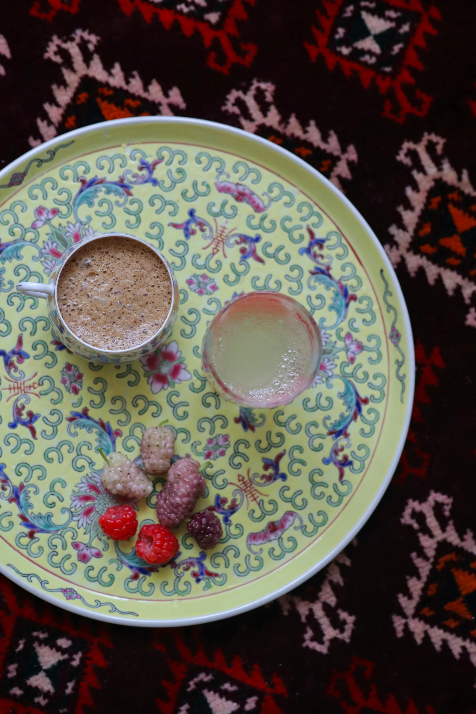 two beverages and food items on a colorful plate