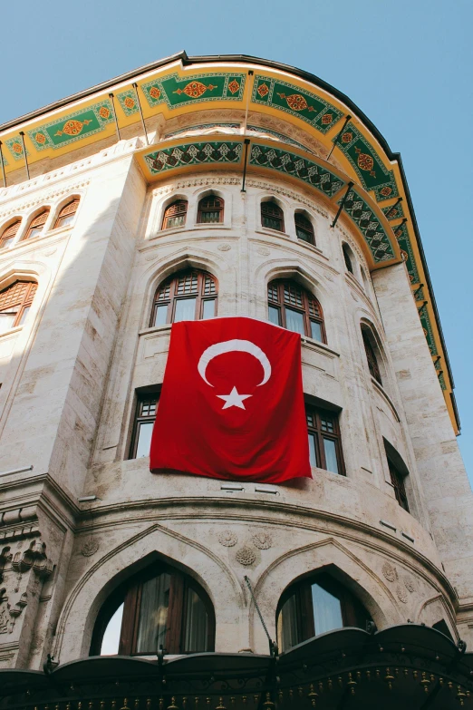 an old building with a flag flying on top of it