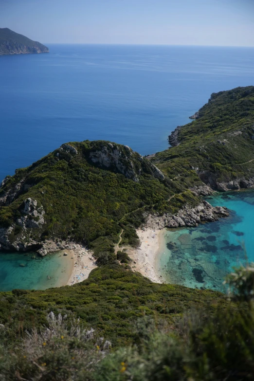 an island is surrounded by water and green vegetation