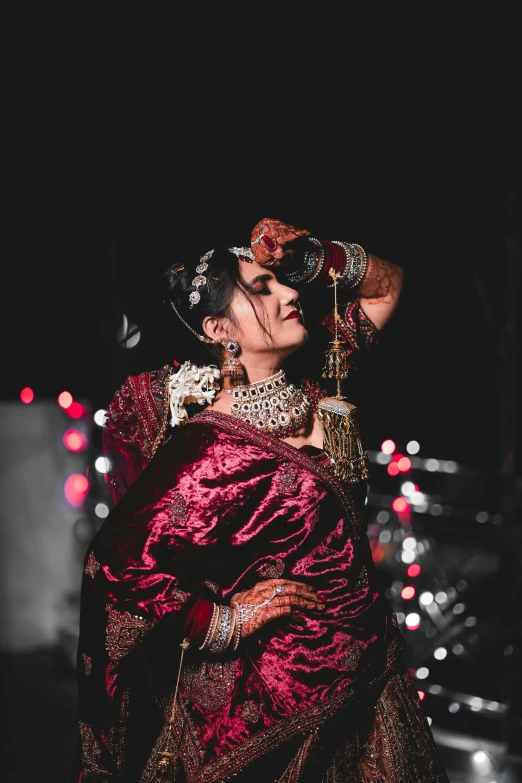 a woman dressed in an indian garb poses for a picture