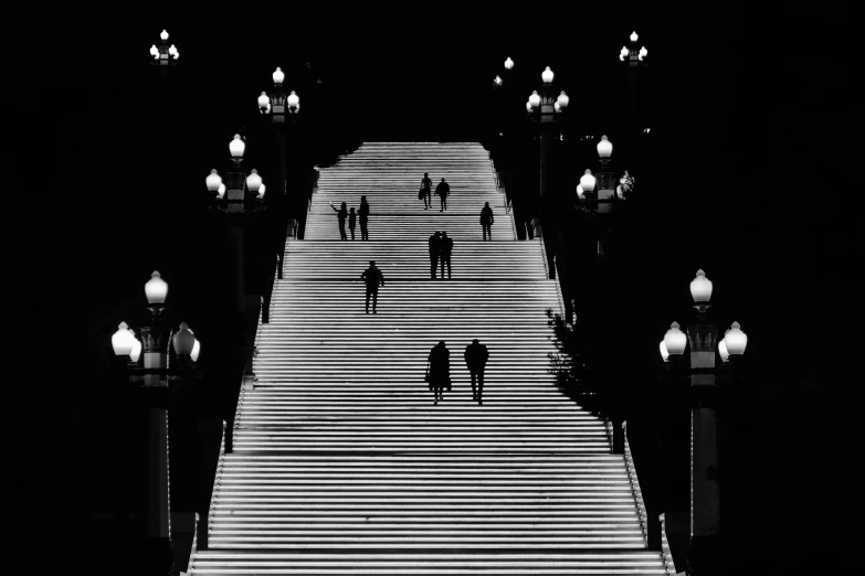 a group of people crossing a long walkway