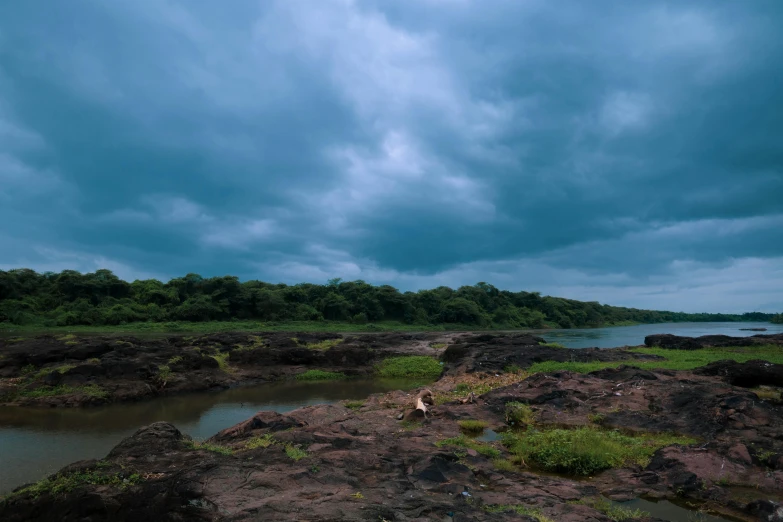 there is a body of water that has a sky full of clouds