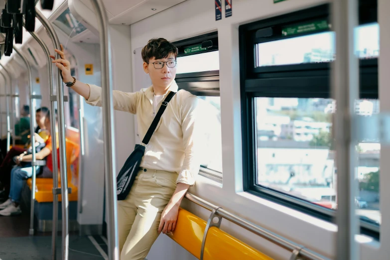 the woman is standing by the window on the bus