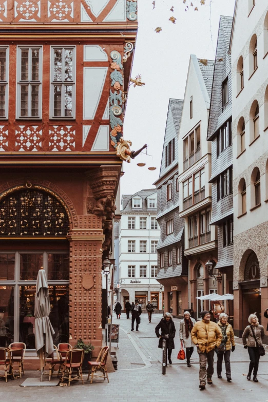 people walking along the street in an old european town