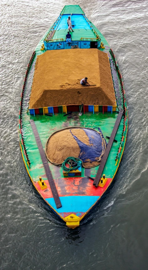 the back side of a long boat with some people inside