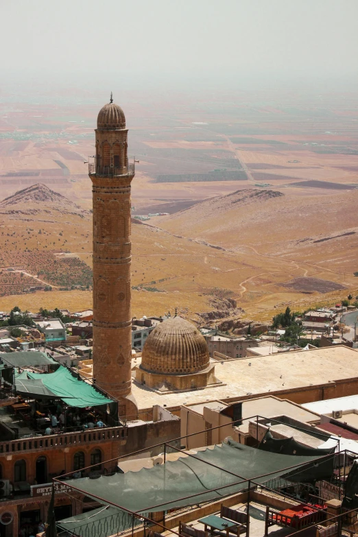 a tall building in a desert area with a sky line