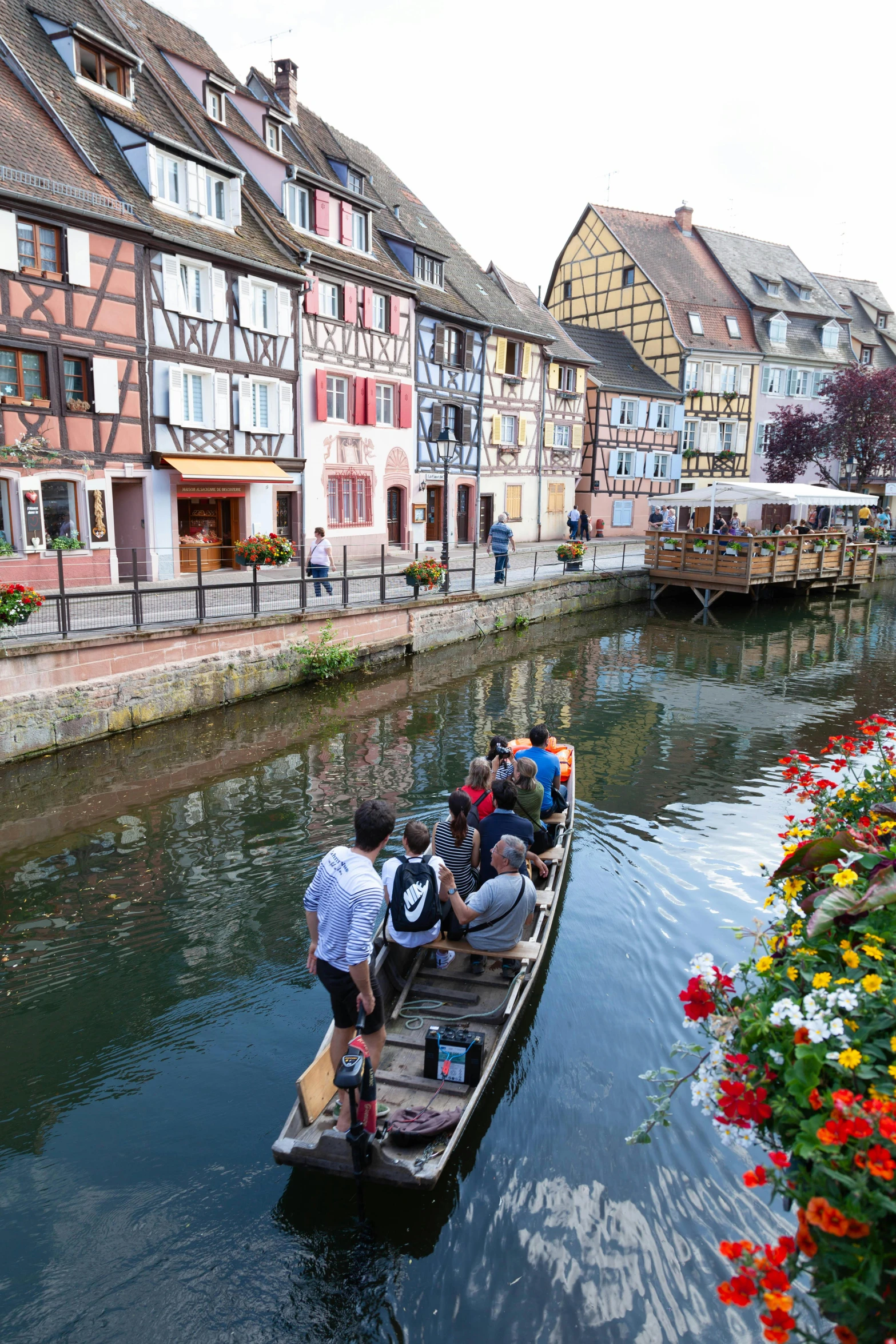 people are on a small boat that has a lot of flowers in it