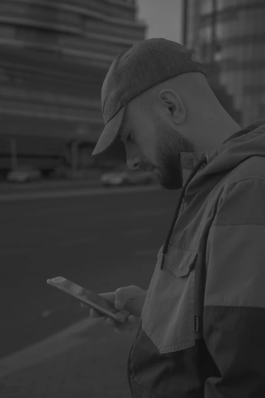 black and white pograph of a man on his phone