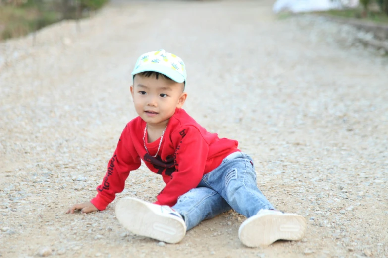 a little boy in a red shirt is posing for a po