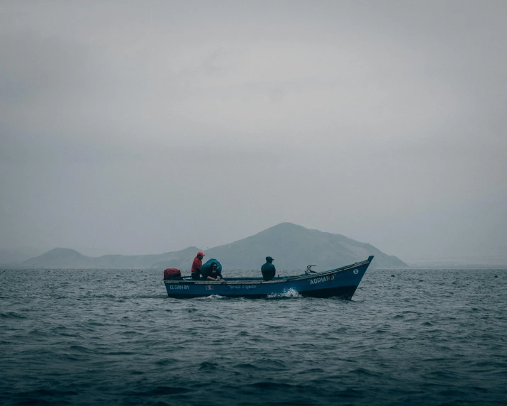 the man is riding in the boat on the water