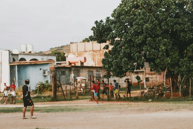 a group of people playing ball in the yard