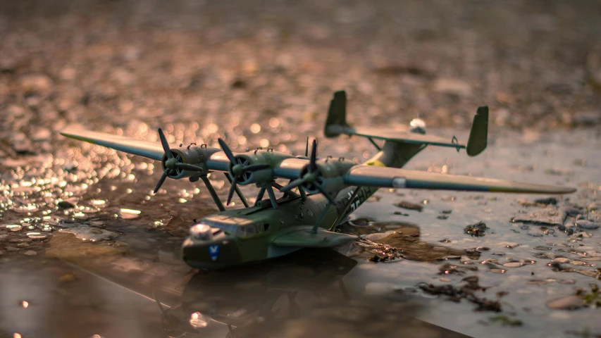 a toy airplane sitting on the ground in front of a dle
