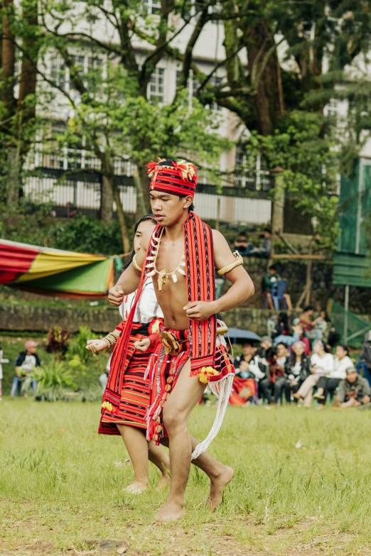 two dancers in red and black clothing at an event