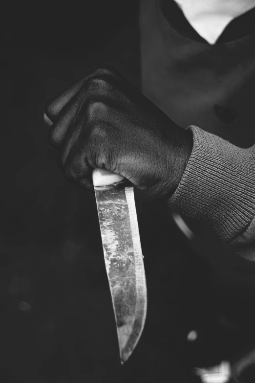 a person holding a knife with both hands