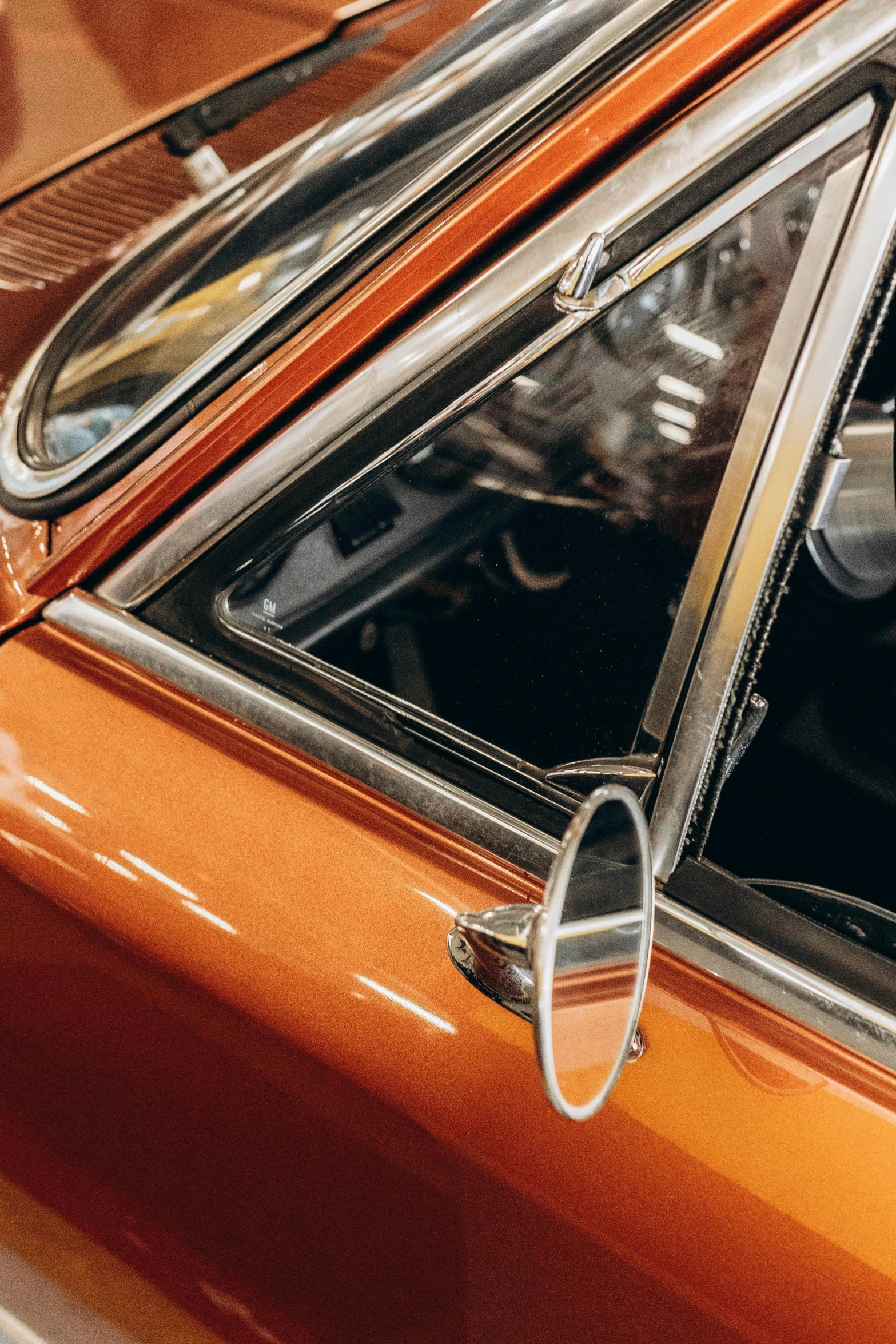 an orange car with a seat hanging out the window