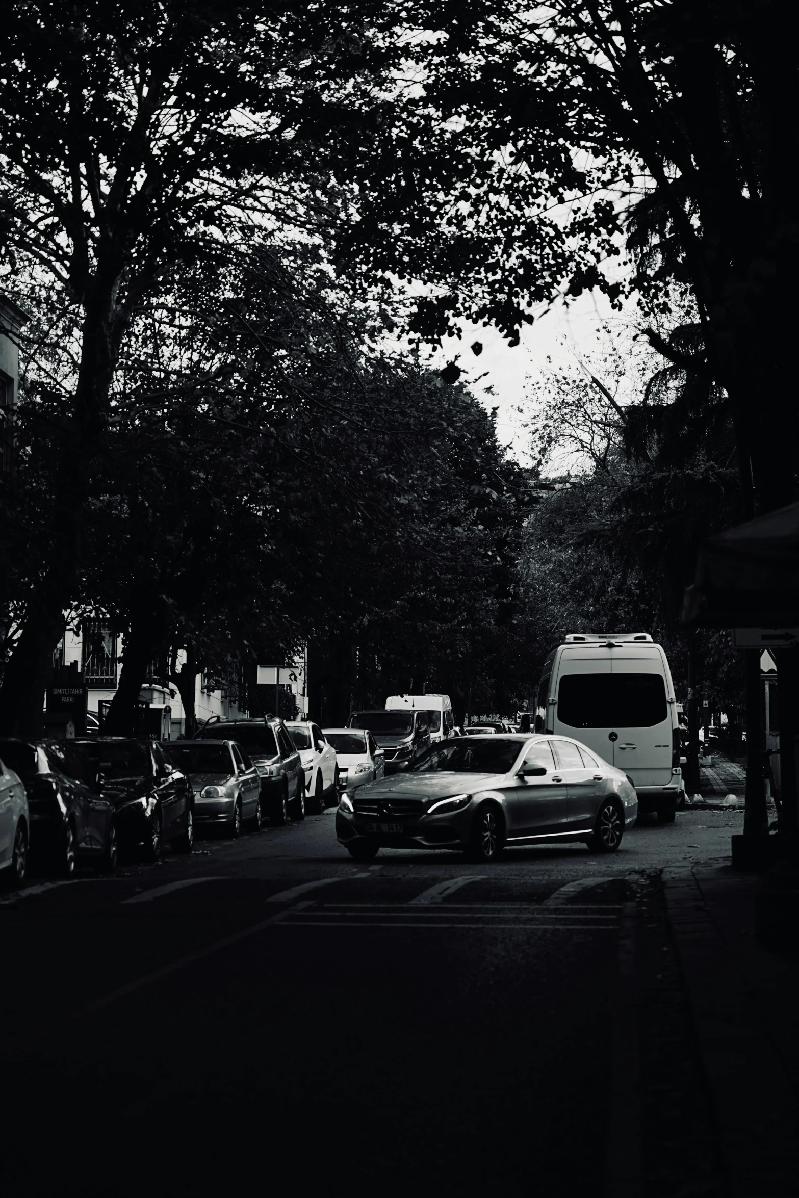 the city street is very dark and crowded