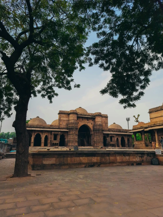 there is a large stone structure under the tree