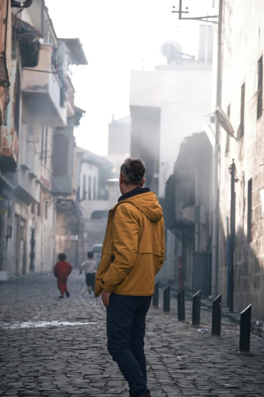 an old man walking down the street looking to his left