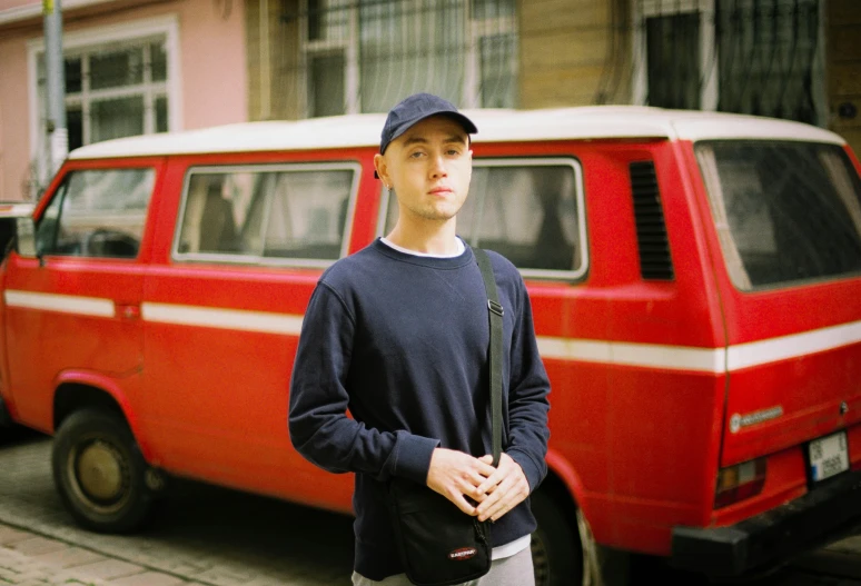 a man stands next to a parked van