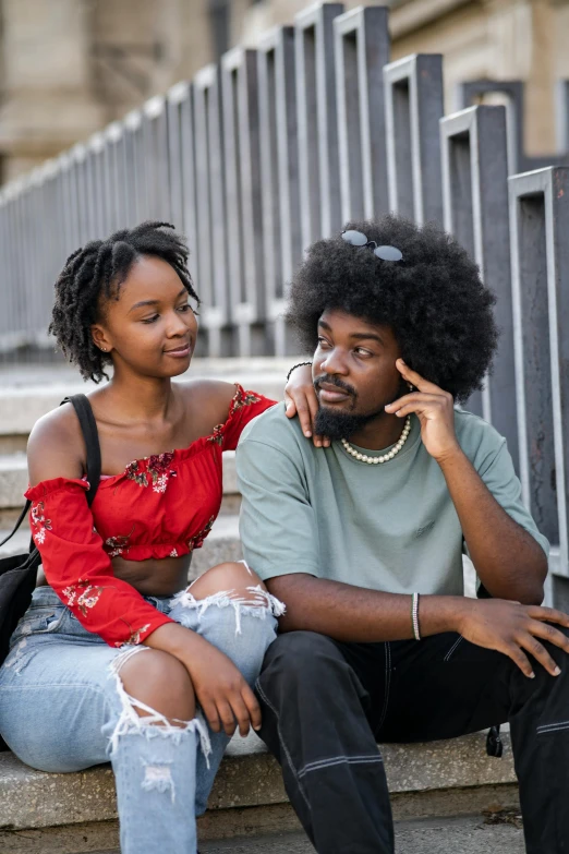 a man talking on his phone while sitting next to a woman