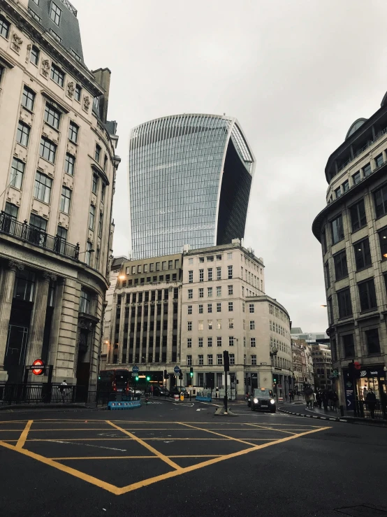 a parking lot next to two large buildings in a city