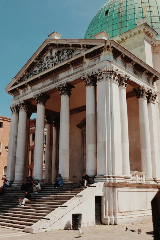 tourists are gathered at an ancient building in the city