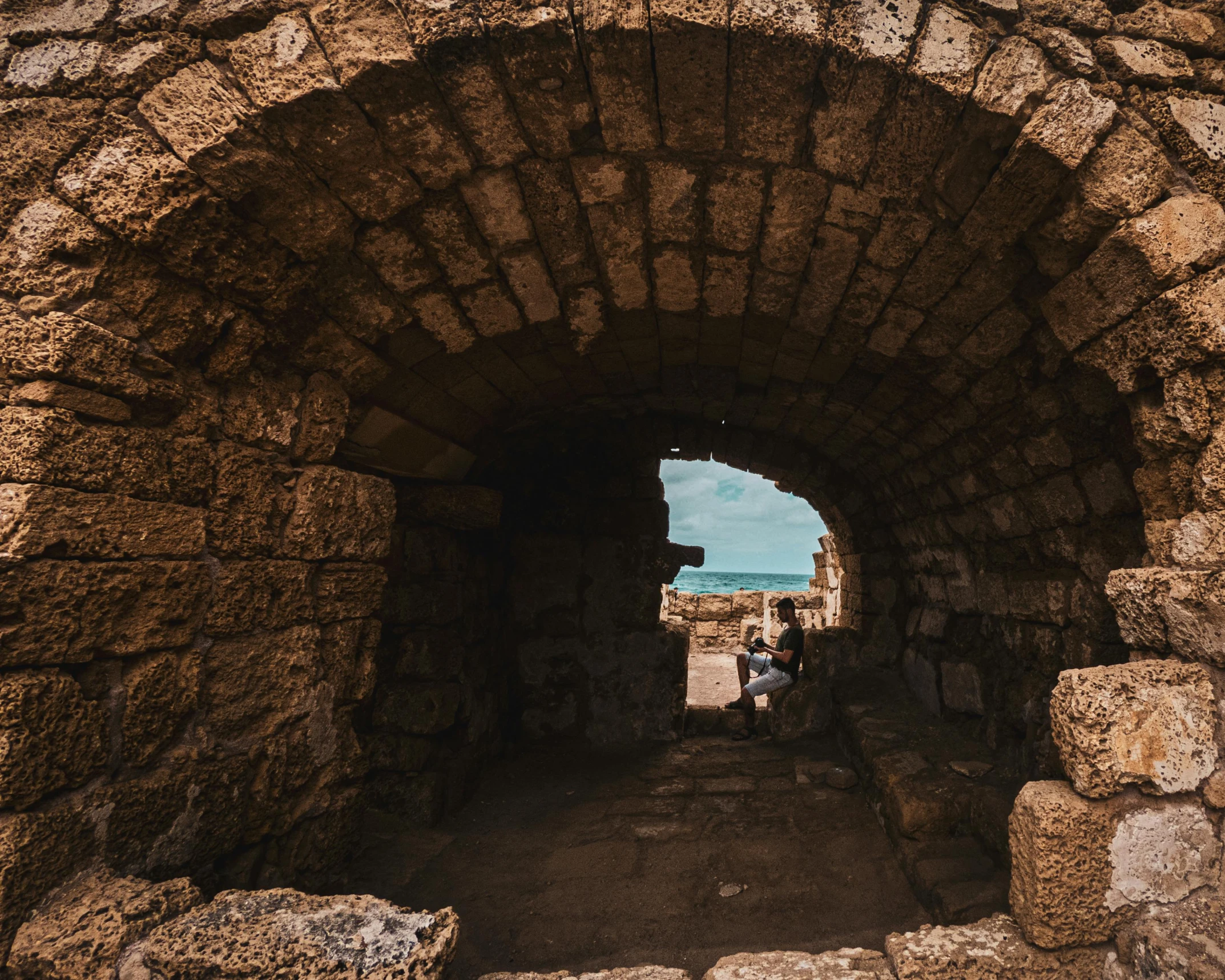 a tunnel entrance into the ground with bricks on both sides