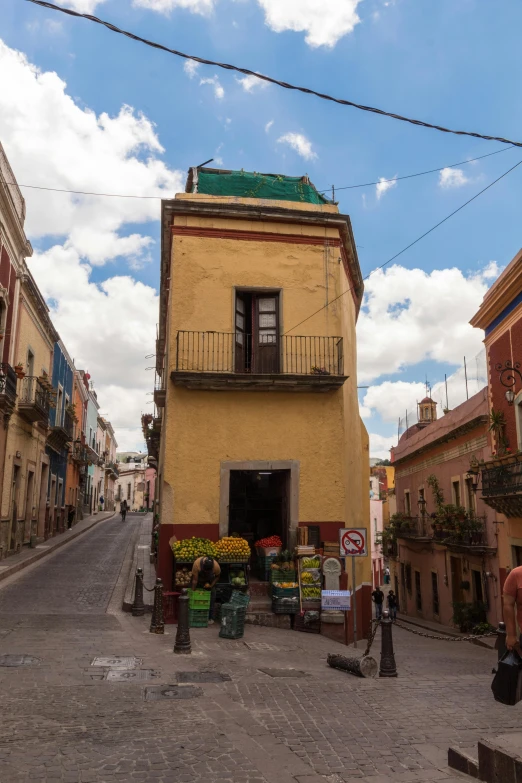 a corner with a building in the middle and a sidewalk