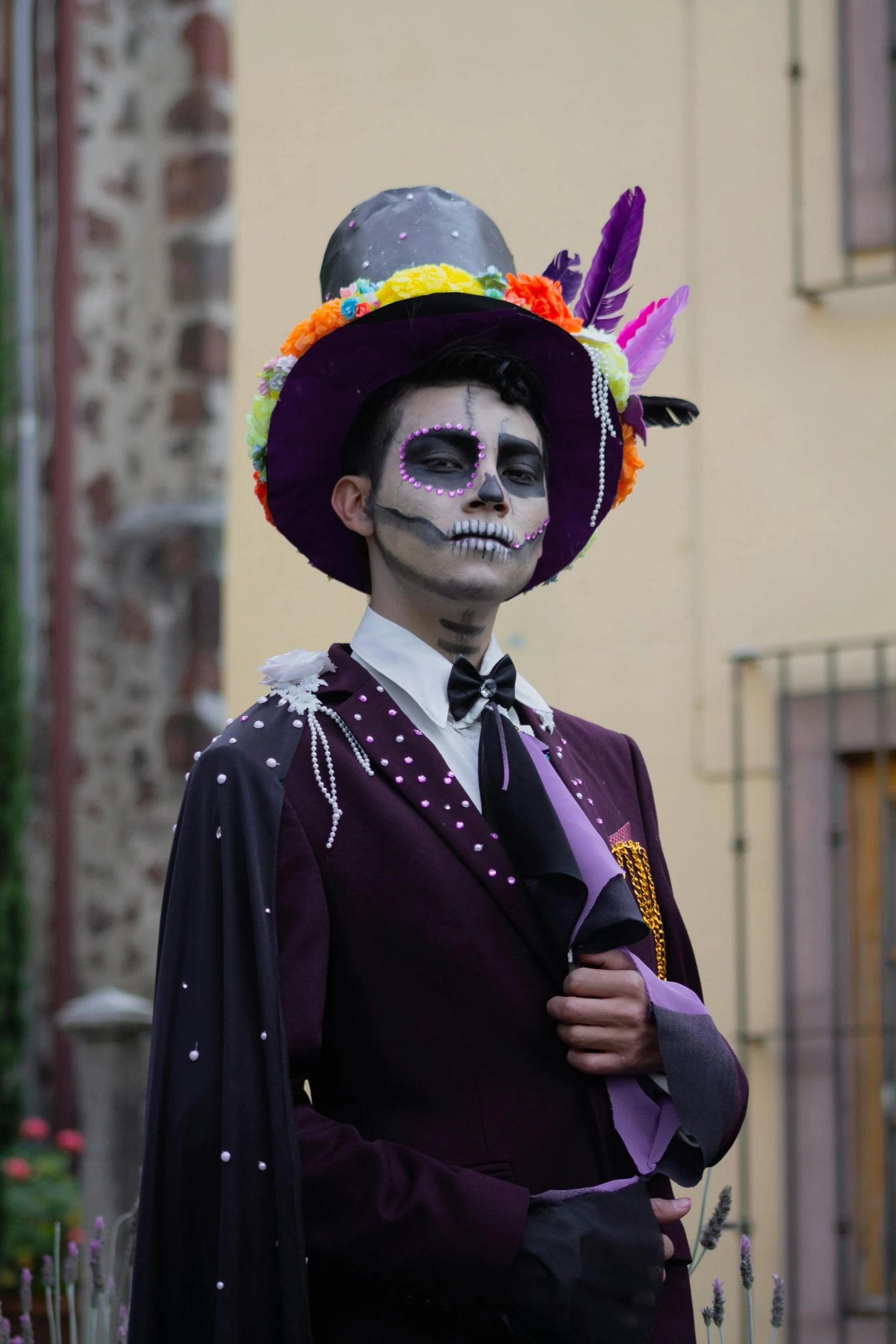 a man wearing skeleton make up and day of the dead attire