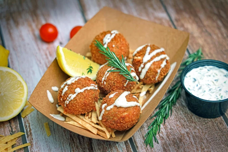 a box filled with food next to a lemon wedge