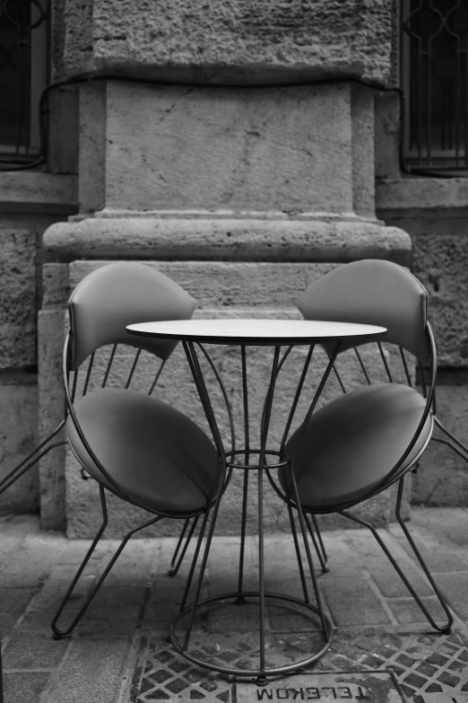 a table with chairs on top of it in front of a building