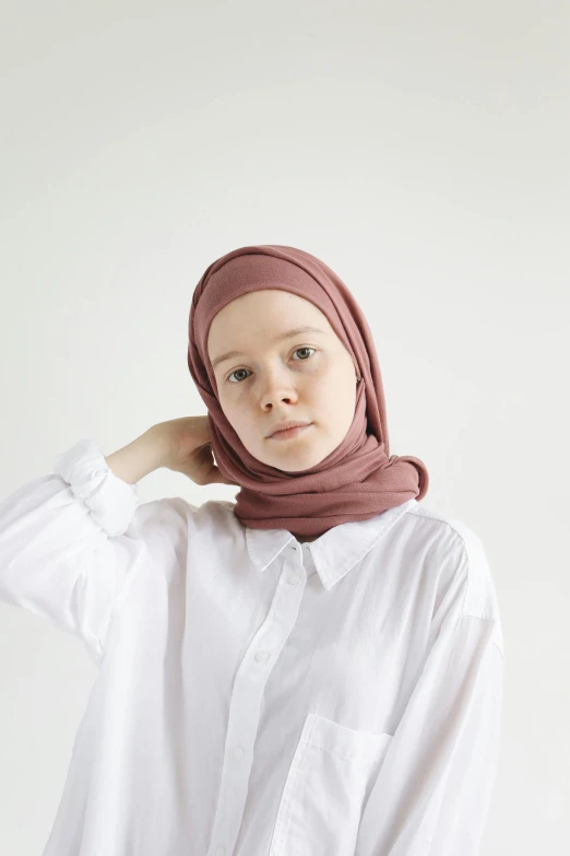 young person in white blouse and scarf posing