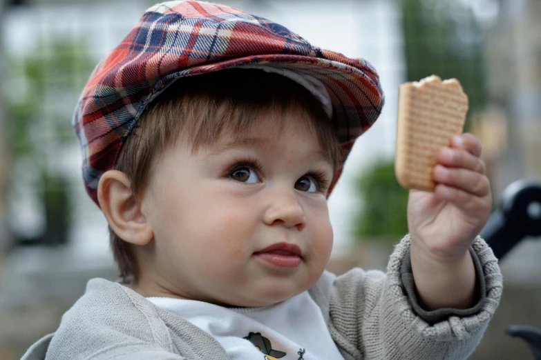 a  in a plaid hat is holding a er