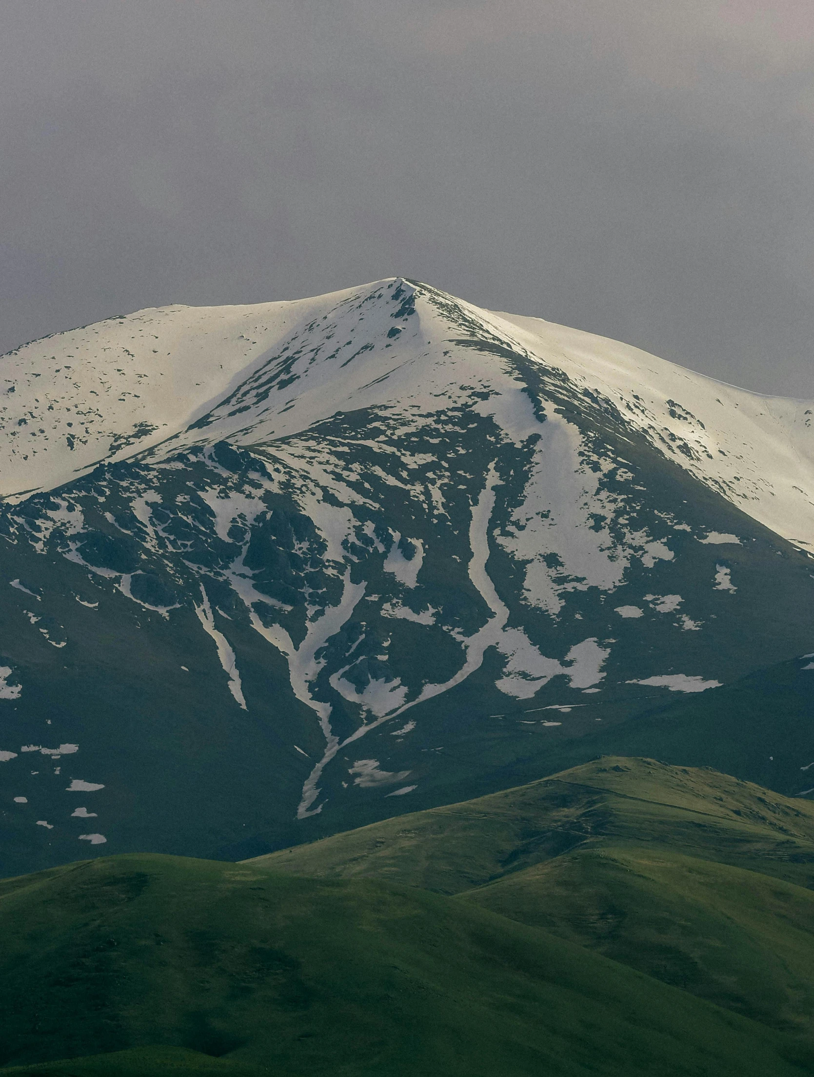 a mountain peak with snow on the top