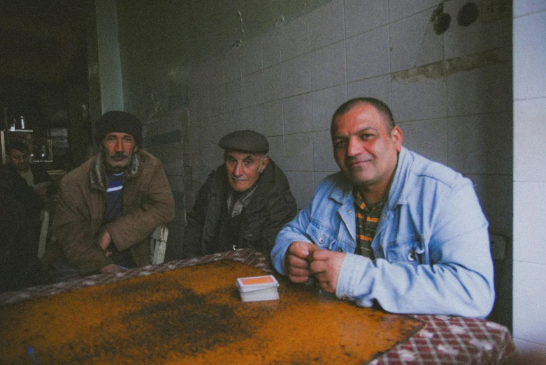 some people sitting at a table with a cell phone