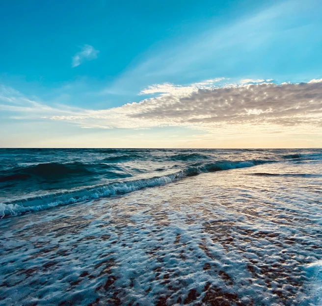 the waves are beginning to break on the beach