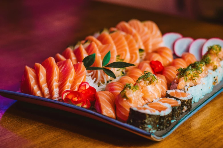 large and colorful sushi dish on a blue plate