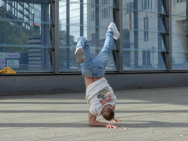 a man standing upside down on his stomach with both hands and  out to the ground