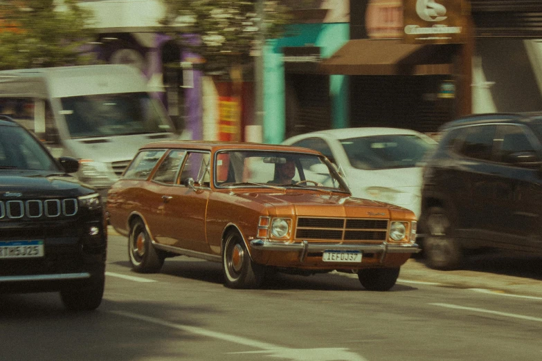 old cars traveling in the middle of a busy city street