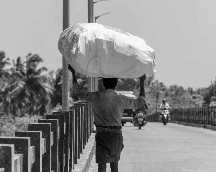 a man carries a large amount of white material