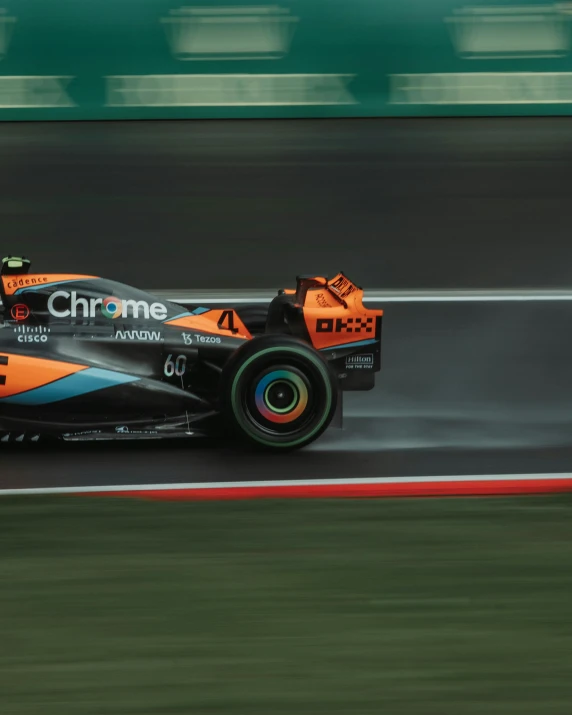 a race car driving down the track with its front wheels in motion